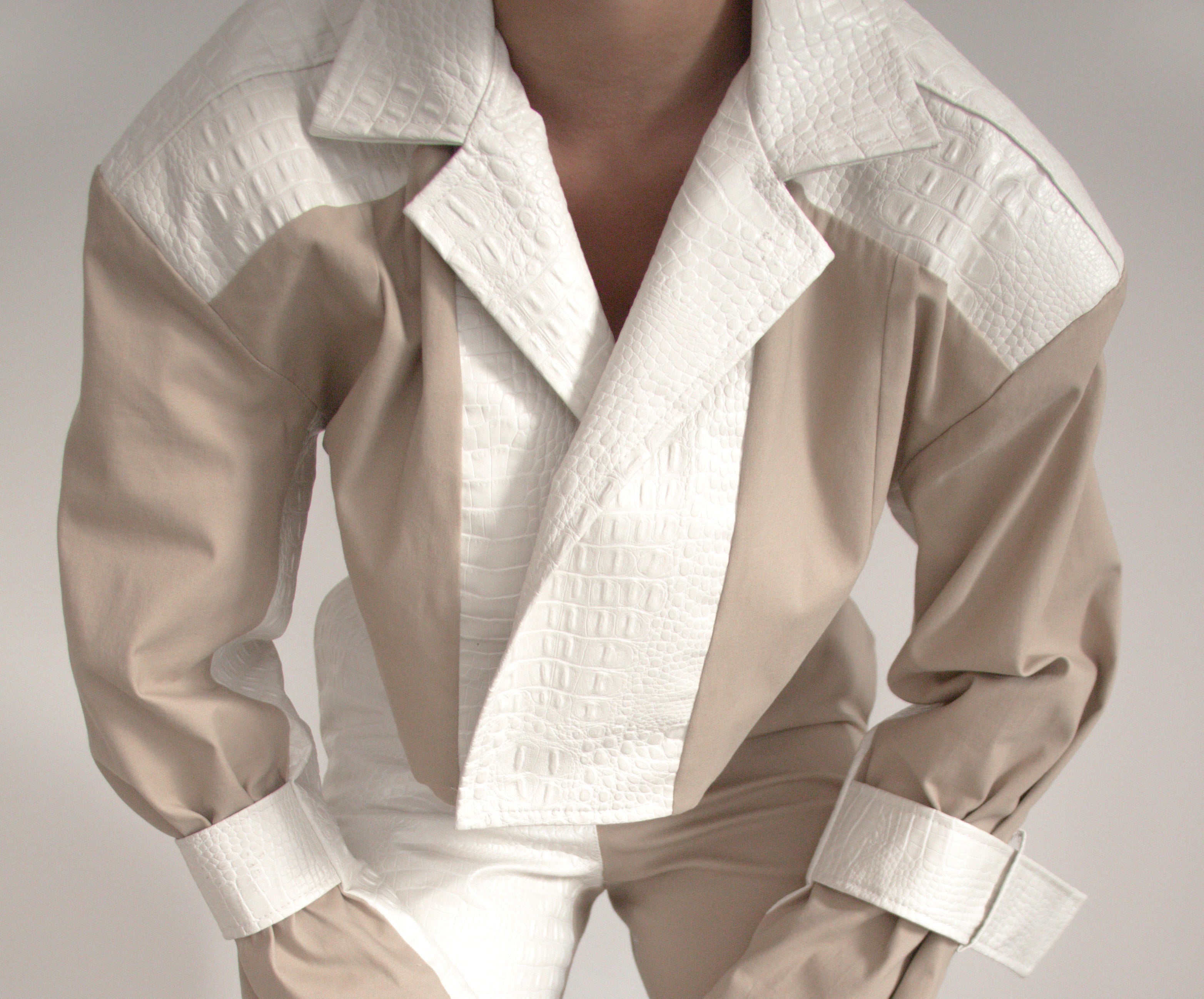 Cropped blazer made with pearl white faux crocodile leather and nude gabardine. rigash